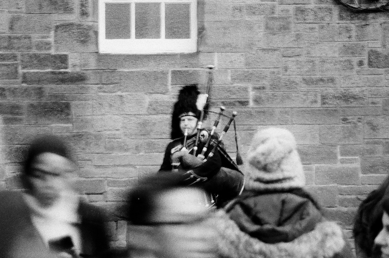 Busker playing a traditional instrument on the streets of Edinburgh
